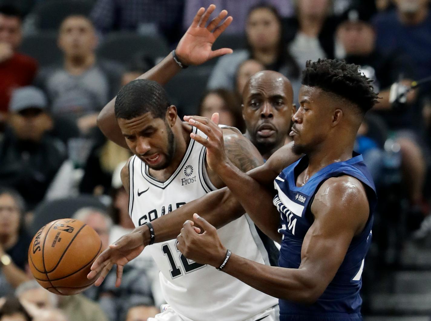 Spurs forward LaMarcus Aldridge and Timberwolves guard Jimmy Butler scrambled for a rebound during the first half Wednesday night.