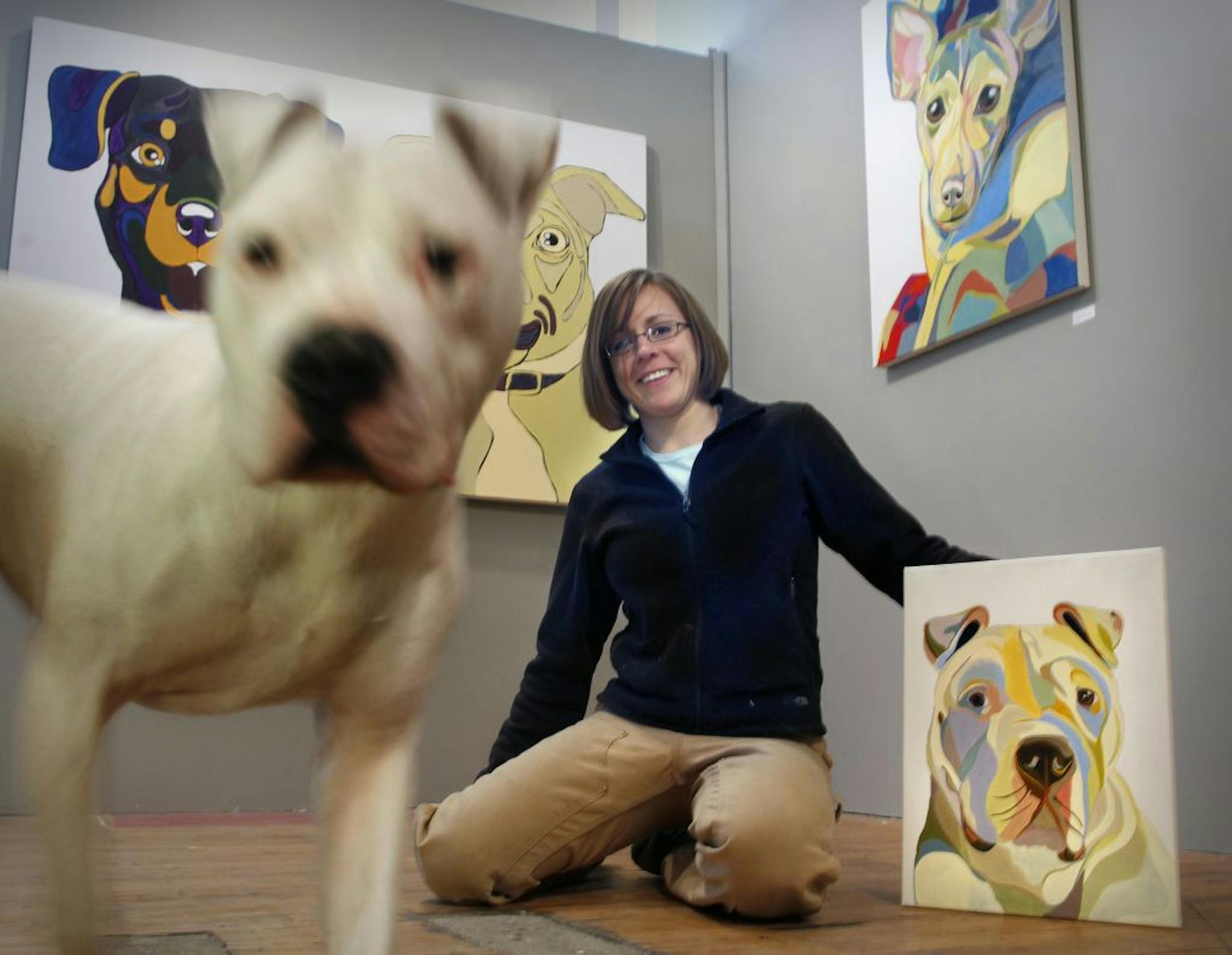 Pet portraitist Sarah Thornton with her pup George at Lintu Art in the Northrup King Building.