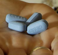 FILE - In this May 10, 2012, file photo, a doctor holds Truvada pills in her office in San Francisco. Studies released on Tuesday, June 11, 2019 show 