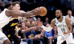 Wolves star Anthony Edwards, left, and Denver Christian Braun battled for the ball as Wolves guard Mike Conley moved in Sunday night in Denver.