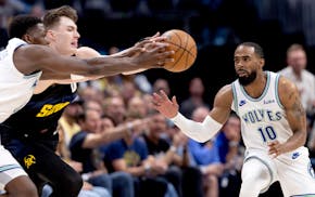 Wolves star Anthony Edwards, left, and Denver Christian Braun battled for the ball as Wolves guard Mike Conley moved in Sunday night in Denver.