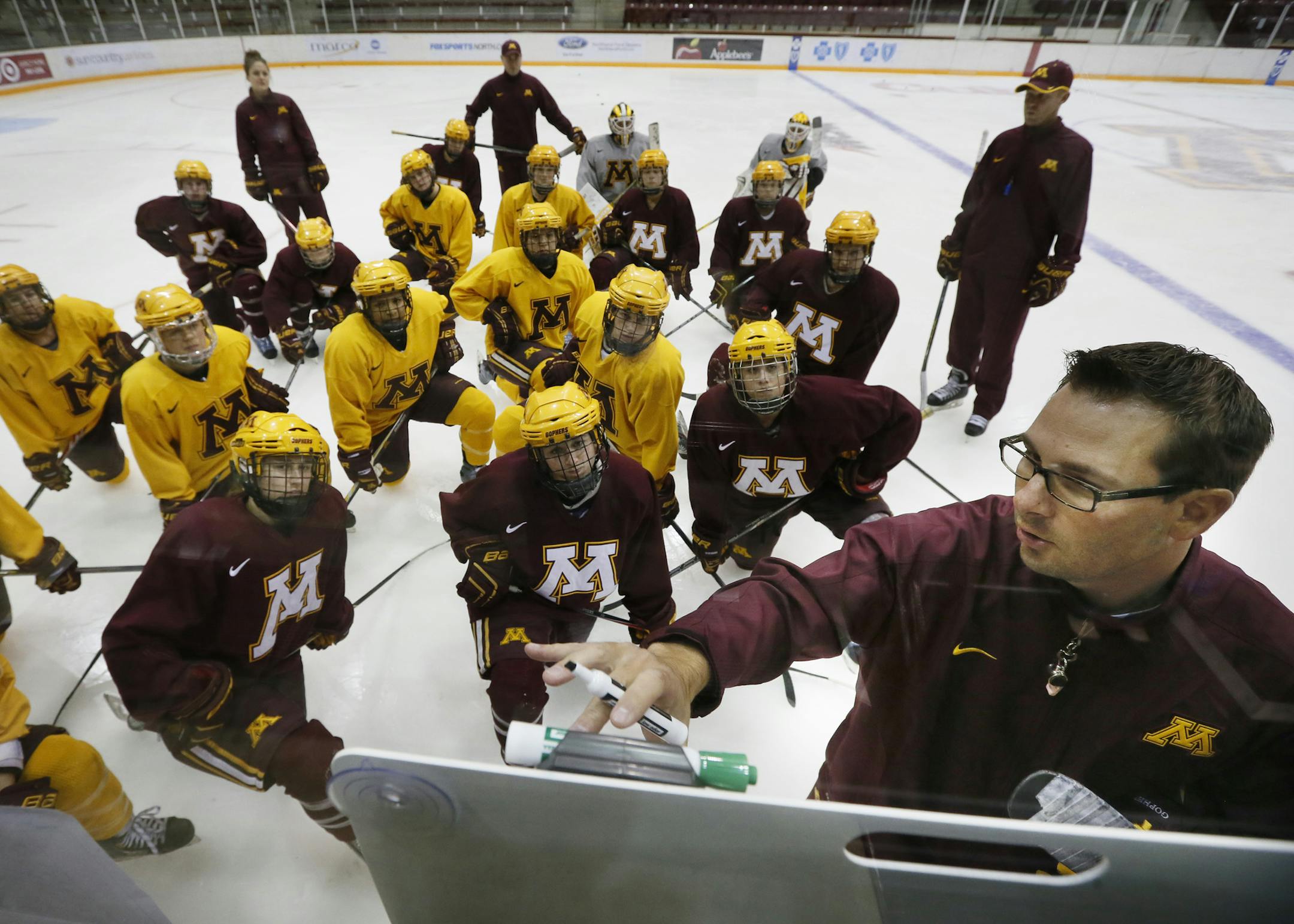Minnesota coach Brad Frost go over plays with his team during practice.The University of Minnesota women's hockey team practiced Tuesday September 30 , 2014 at Ridder Arena in Minneapolis ,MN. ] Jerry Holt Jerry.holt@startribune.com