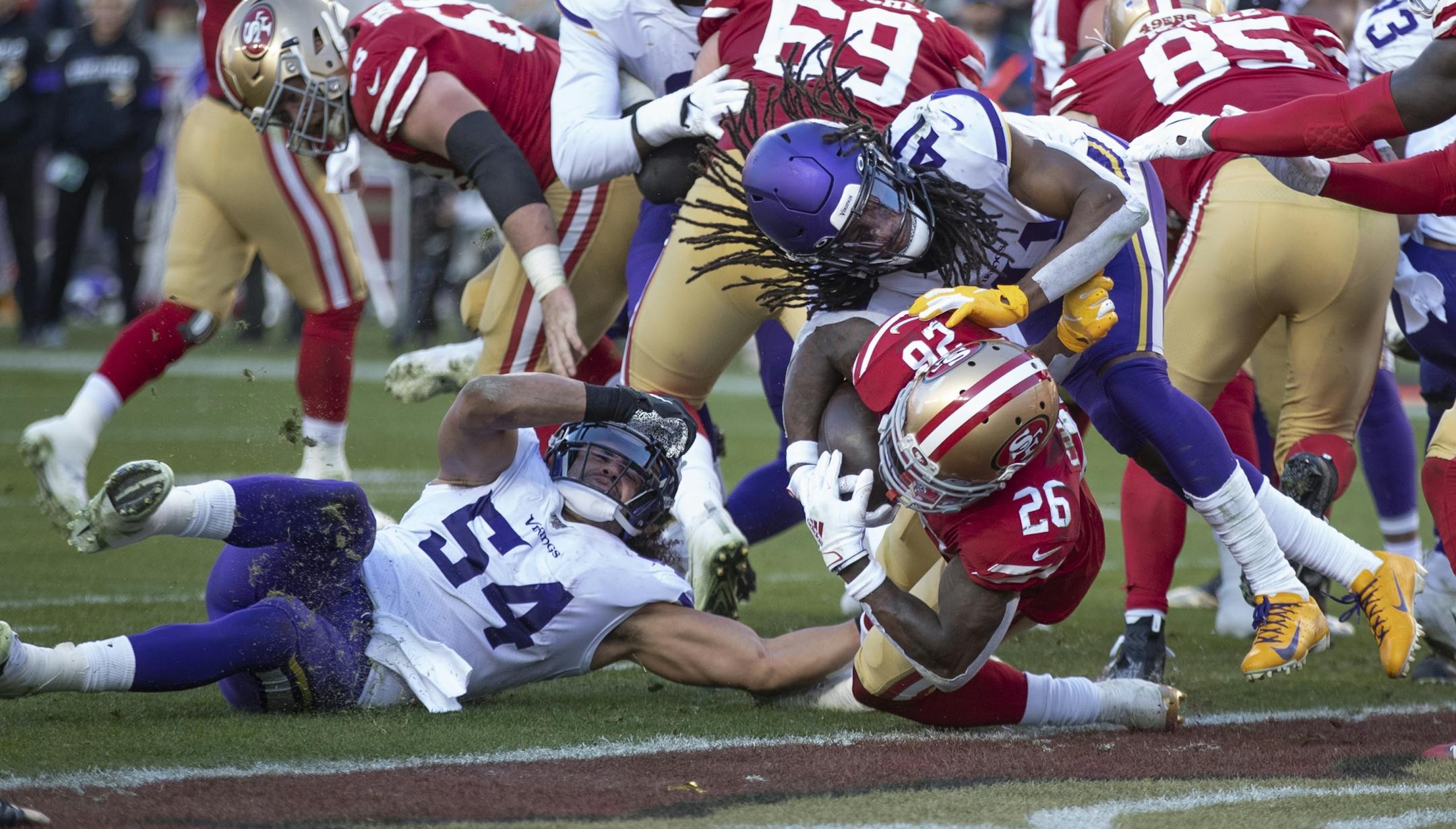 San Francisco 49ers running back Tevin Coleman plowed through Minnesota Vikings middle linebacker Eric Kendricks, left, and defensive back Anthony Harris for a touchdown in the third quarter.