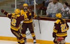 Grace Zumwinkle (12) and Taylor Wente (28) celebrate the Gophers' first goal vs. Wisconsin in the 2018 WCHA Final FaceOff.