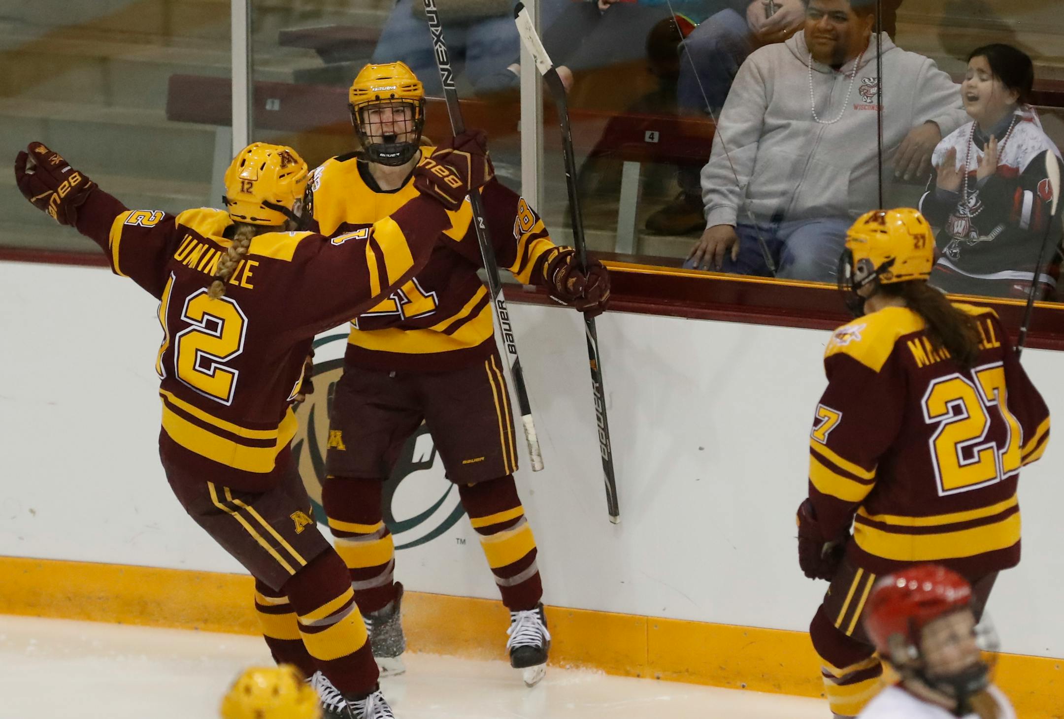 Grace Zumwinkle (12) and Taylor Wente (28) celebrate the Gophers' first goal vs. Wisconsin in the 2018 WCHA Final FaceOff.