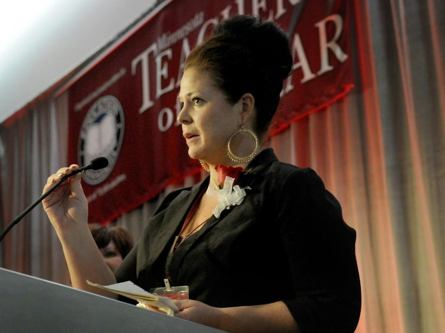 In this photo provided by Education Minnesota, Amy Hewett-Olatunde speaks after being named 2015 Minnesota Teacher of the Year by Education Minnesota in Bloomington, Minn., Sunday, May 3, 2015. Hewitt -Olatunde teaches ESL at LEAP High School in St. Paul, Minn.