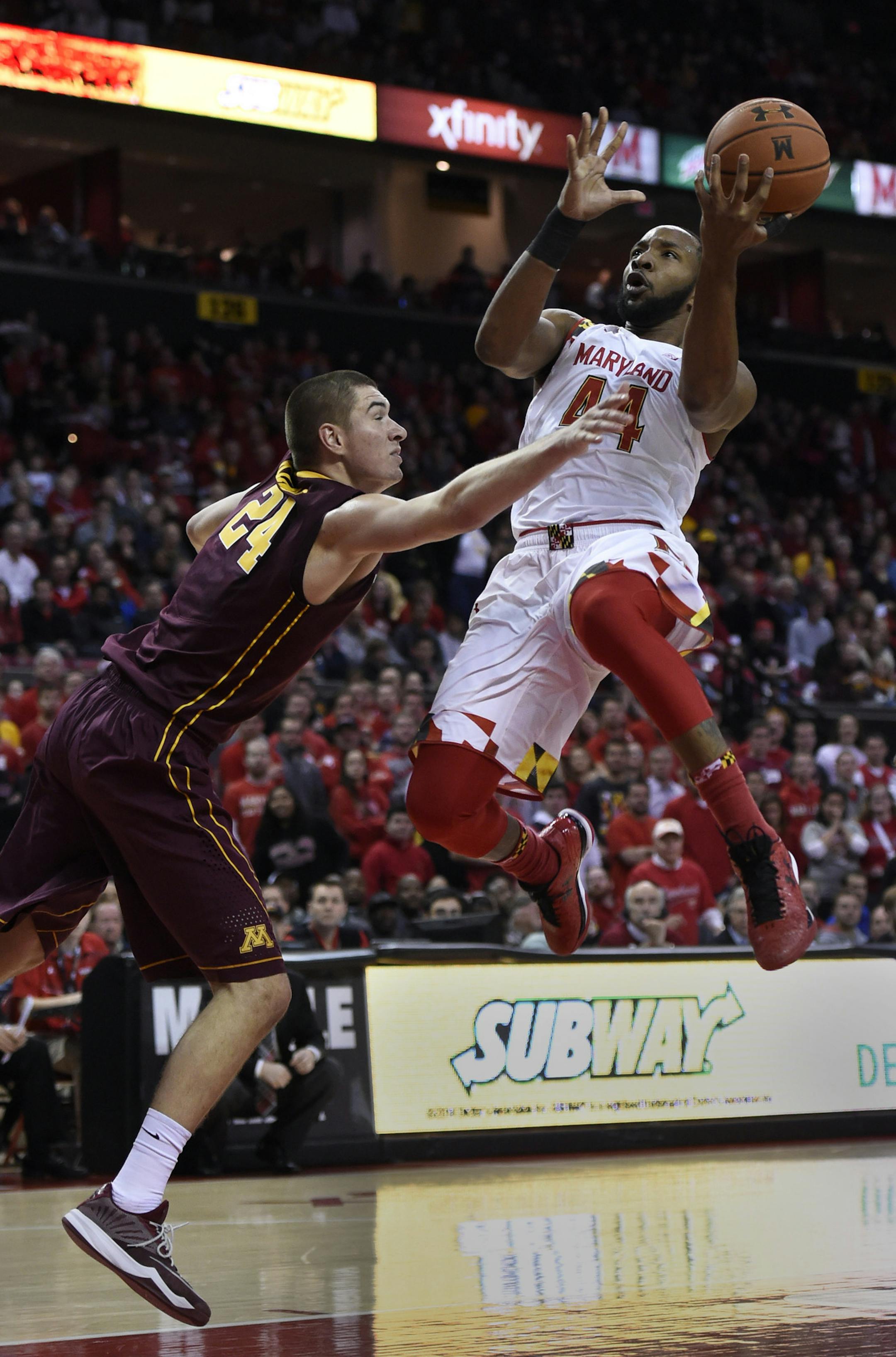 Maryland guard Dez Wells shoots as Minnesota forward Joey King defends, right, during the second half of an NCAA college basketball game Saturday, Jan. 3, 2015 in College Park, Md. Maryland won 70-58. (AP Photo/Gail Burton)
