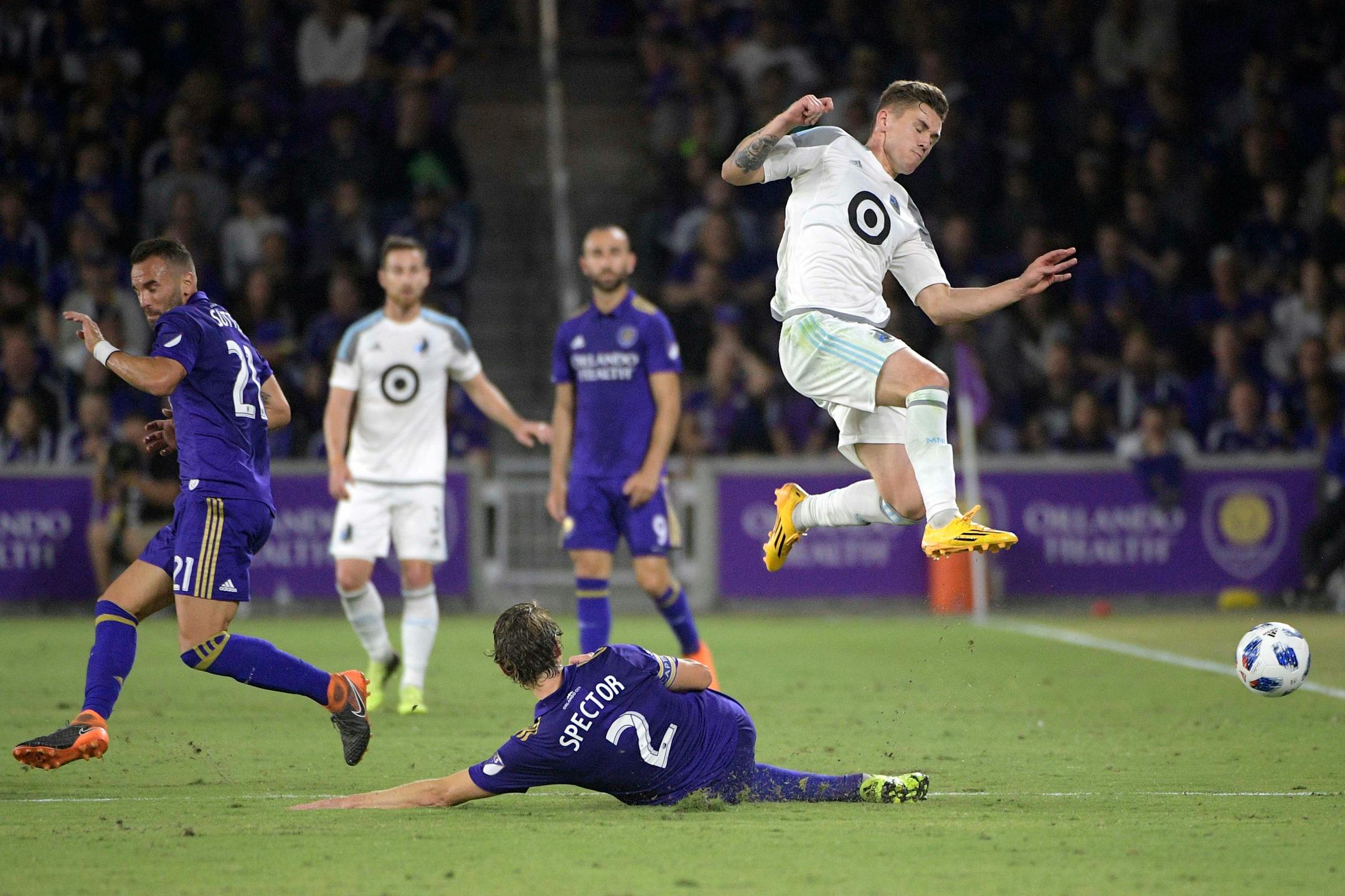 Orlando City defender Jonathan Spector (2) kicks the ball away from Minnesota United midfielder Sam Nicholson (12), right, during the first half of an MLS soccer match Saturday, March 10, 2018, in Orlando, Fla. Minnesota won 2-1. (Phelan M. Ebenhack for the Star-Tribune) ORG XMIT: OTKMINN117