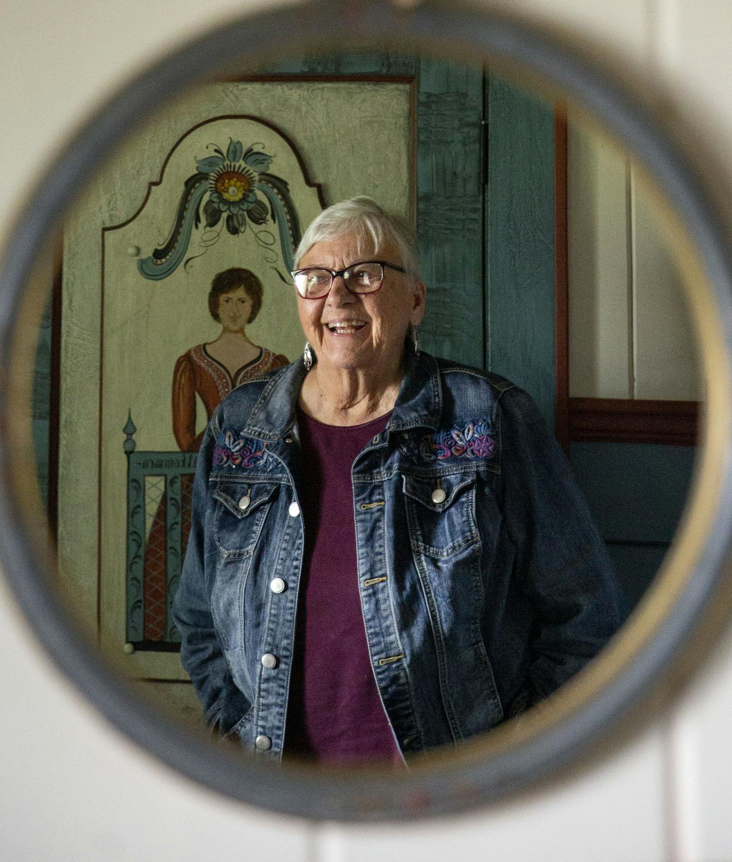 Karen Jenson is reflected in a small hanging mirror in the Swedish room. ALEX KORMANN &#xa5; alex.kormann@startribune.com Karen Jenson is an 82-year-old artist who spent most of her life mastering the Norwegian and Swedish painting styles of rosemaling and dalamaling, respectively. She no longer lives in the home and is in the process of transforming it into a museum or artist's residence.