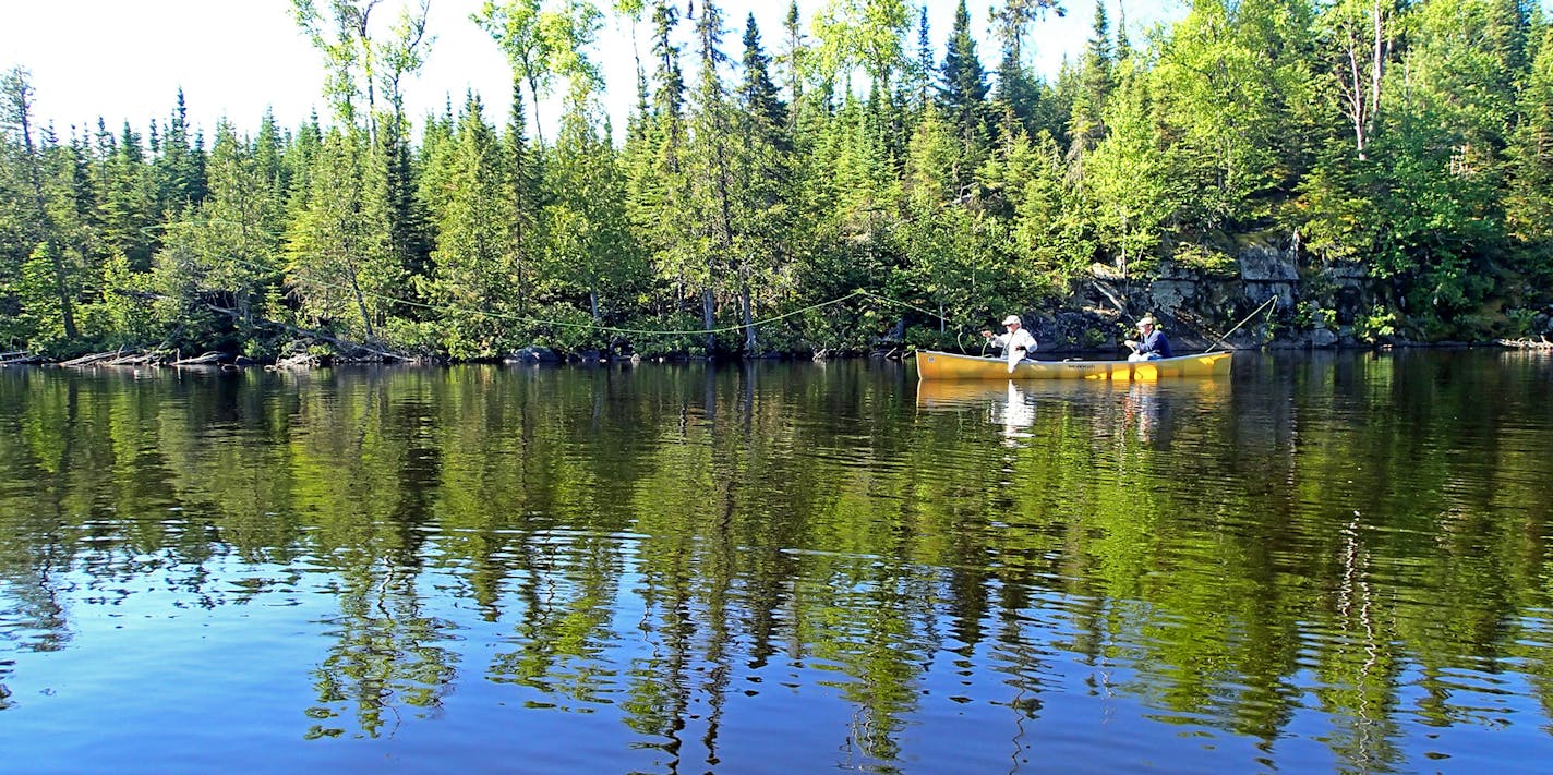 Bob Nasby of St. Paul cast for smallmouth bass, while Joe Friedrichs guided the canoe from its stern. Friedrichs works out of Rockwood Lodge on Poplar Lake on the Gunflint Trail.