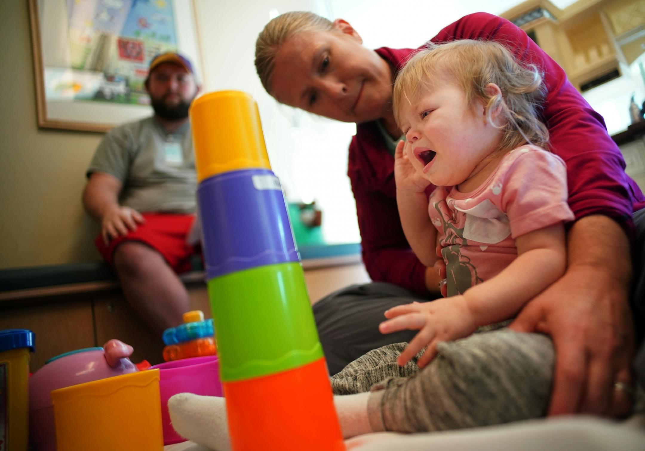 Occupational therapist Carrie Henchal helps Aria with her core/trunk strength. AFM has caused partial paralysis in Aria's left leg and has made turning over and sitting up painful challenges.