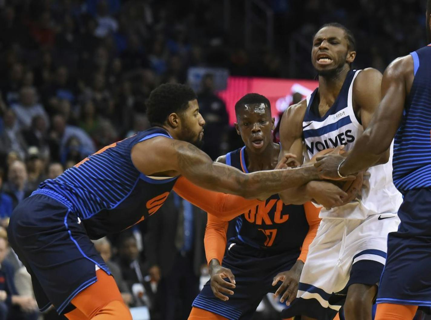 Oklahoma City Thunder forward Paul George, left, tries to get the ball away from Minnesota Timberwolves guard Andrew Wiggins, right, in the first half of an NBA basketball game in Oklahoma City, Sunday, Dec. 23, 2018.