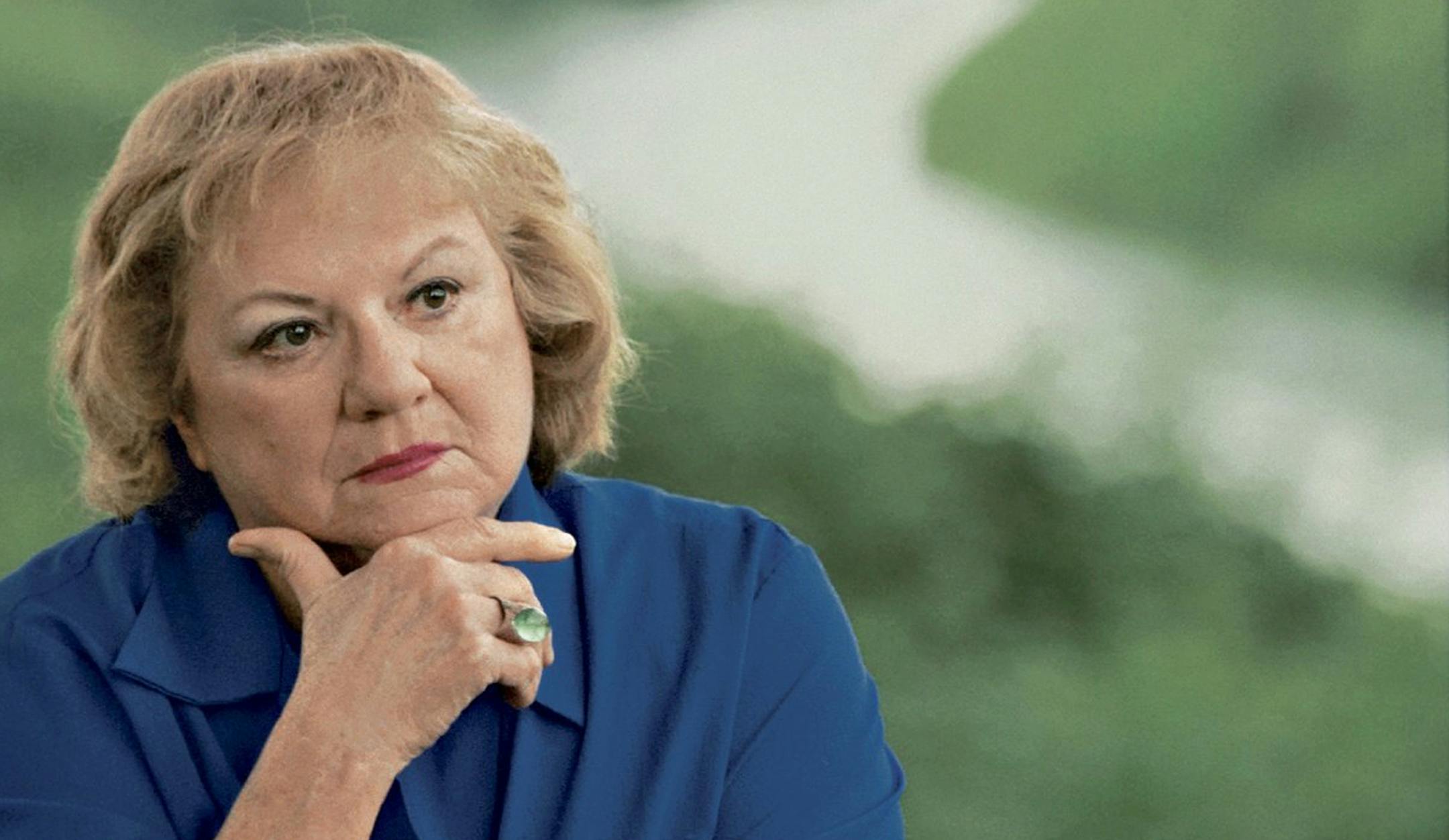 FILE - This July 2004 file photo shows, true-crime author Ann Rule, who wrote a book about serial killer Gary Ridgway, who left some of his victims' bodies along the Green River outside Seattle, Wash., shown in the background. Rule, who wrote more than 30 books, including a profile of her former co-worker, serial killer Ted Bundy, has died at age 83. Scott Thompson, a spokesman for CHI Franciscan Health, said Rule died at Highline Medical Center at 10:30 p.m. Sunday, July 26, 2015. (Betty Udeson