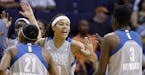 Minnesota Lynx's Seimone Augustus, middle, celebrates with Renee Montgomery (21) and Natasha Howard (3) as the Lynx take an early lead against the Pho