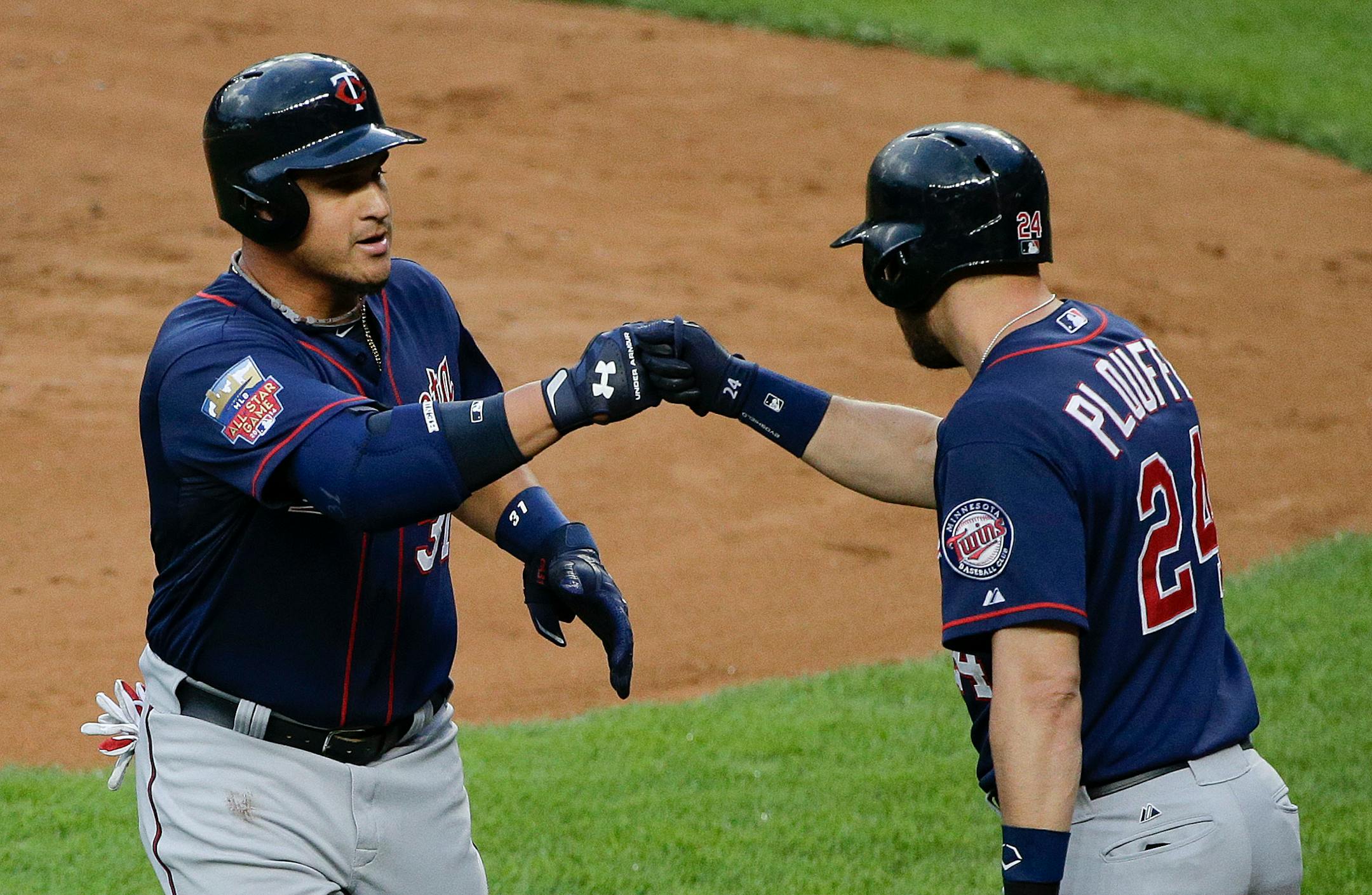 Minnesota Twins' Oswaldo Arcia (31) is greeted by teammate Trevor Plouffe (24) after hitting a solo home run during the second inning of a baseball game against the New York Yankees, Friday, May 30, 2014, in New York. (AP Photo/Julie Jacobson)