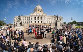 Along with DFL legislative leaders and his commissioners, Gov. Tim Walz threw a bill-signing party Wednesday morning on the Capitol steps.