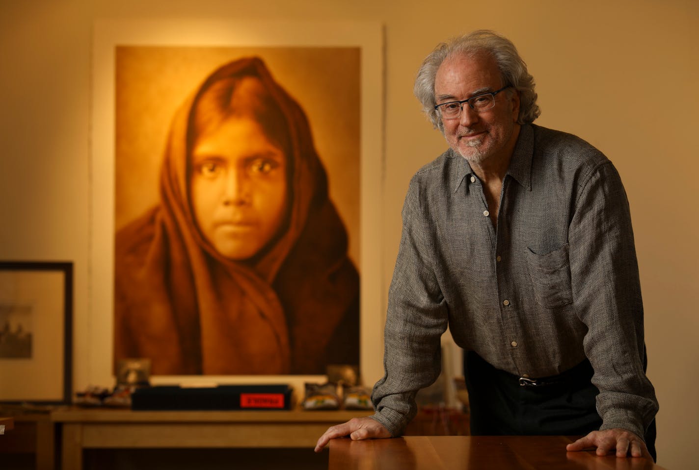 Christopher Cardozo in his Minneapolis office near a large print of the Edward Curtis portrait "Qahatika Girl, 1907.". ] JEFF WHEELER • jeff.wheeler@startribune.com