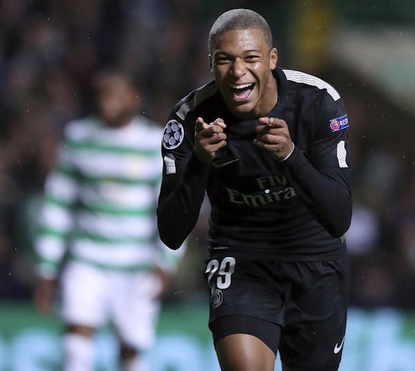 PSG's Kylian Mbappe celebrates after scoring his side's 2nd goal during the Champions League Group B soccer match between Celtic and Paris St. Germain