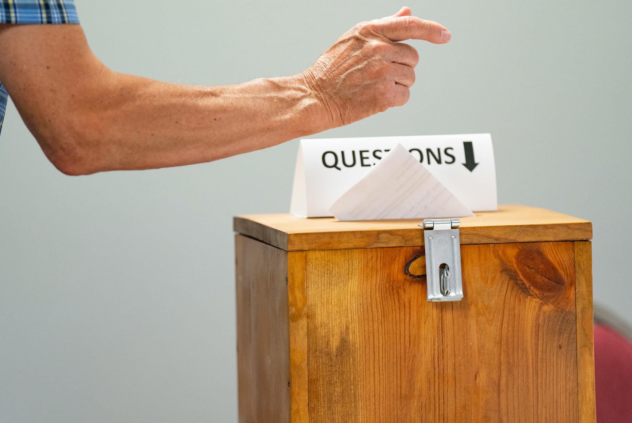 A meeting attendee deposits a question in a box during a DNR public engagement meeting at Kilowatt Community Center.