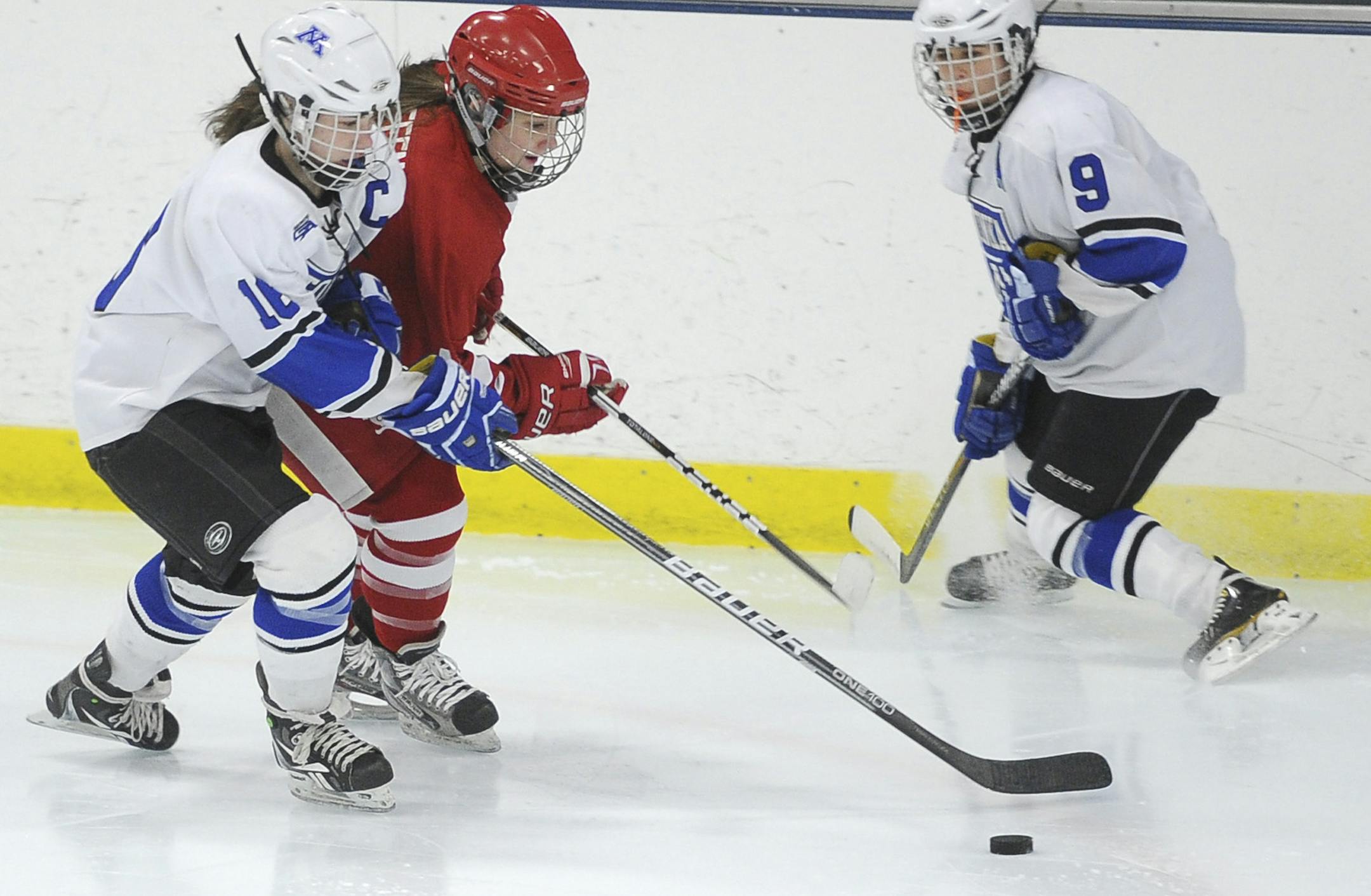 Minnetonka forward Laura Bowman battles Benilde-St. Margaret defender Mekenzie Steffen for the puck on while Minnetonka forward Amy Petersen, right, skates in position Friday, Feb. 15, 2013, on Friday, Feb. 15, 2013, at Parade Ice Garden in Minneapolis. Mark Vancleave/Star Tribune * mark.vancleave@startribune.com * 2/15/13 * ORG XMIT: MIN1302161920013627