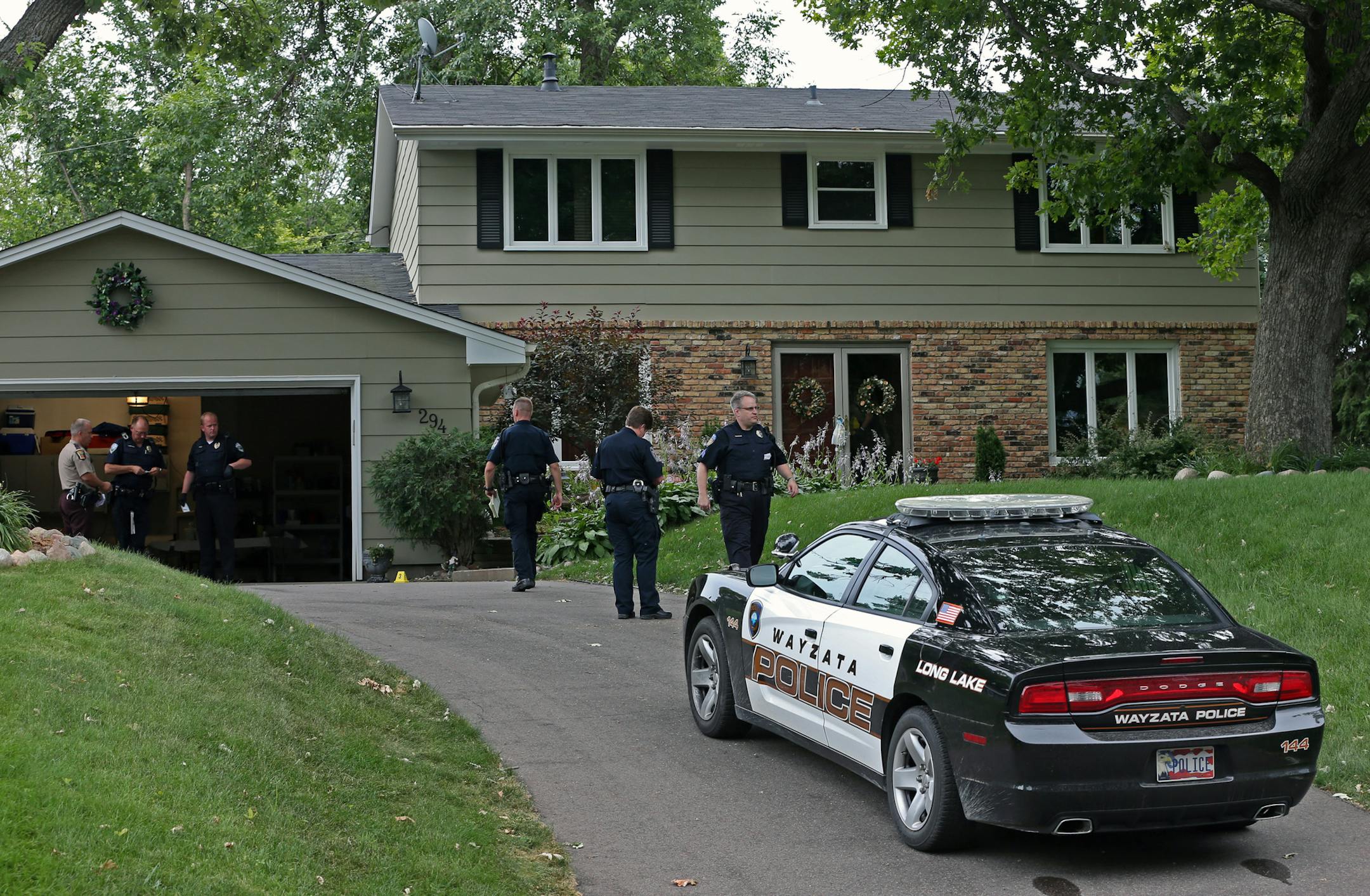 Wayzata police, Plymouth Police, Minnesota State Patrol and Hennepin County Sheriff officers investigated a home invasion at 294 Glenmoor Lane in Long Lake on 7/27/13.] Bruce Bisping/Star Tribune bbisping@startribune.com