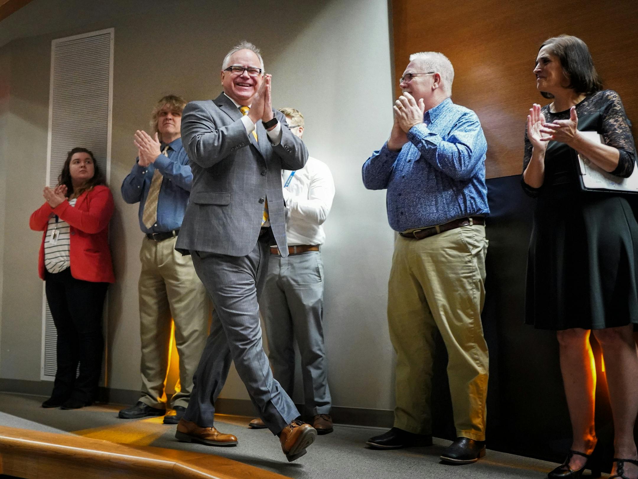 Minnesota Gov. Tim Walz acknowledged applause as he arrived at Waseca Junior/Senior High School.
