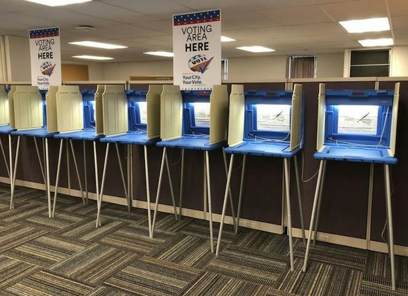 A line of empty voting booths.