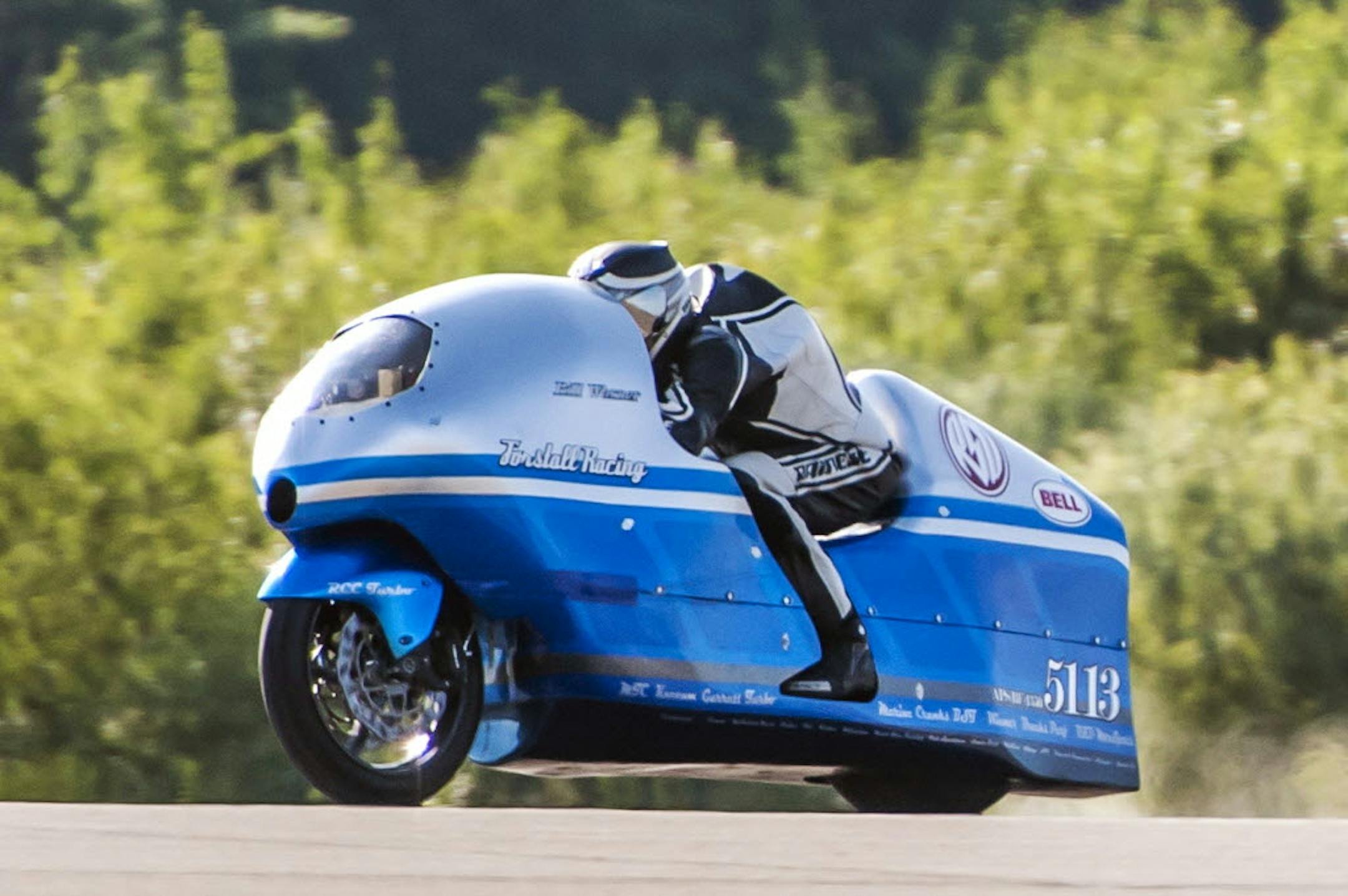 Bill Warner makes a run on his motorcycle during The Maine Event on a runway at a former air base Sunday, July 14, 2013, at Limestone, Maine.