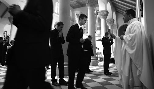 John Wehrly, 27, with hands clasped, walked up to receive the "Blood of Christ" during the mass that opens the school year at The Saint Paul Seminary School of Divinity at the University of St. Thomas. Wehrly originally from Fort Wayne, IN, has always had the god and the Catholic Church as a part of his life. Wehrly took a leap of faith this fall by not pursuing the law degree he just earned but to enroll in The Saint Paul Seminary School of Divinity " I've had this polar, this desire towards th