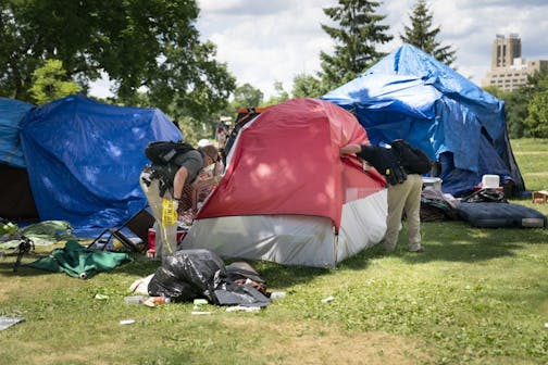 Police looked in a tent to see if there were any occupants before demolishing it and trashing it at the east side homeless encampment at Powderhorn Park in Minneapolis, on Monday, July 20, 2020.