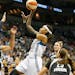 Minnesota Lynx guard Seimone Augustus (33) pushes the ball up to the basket against San Antonio Stars forward Danielle Adams (23) during the first hal