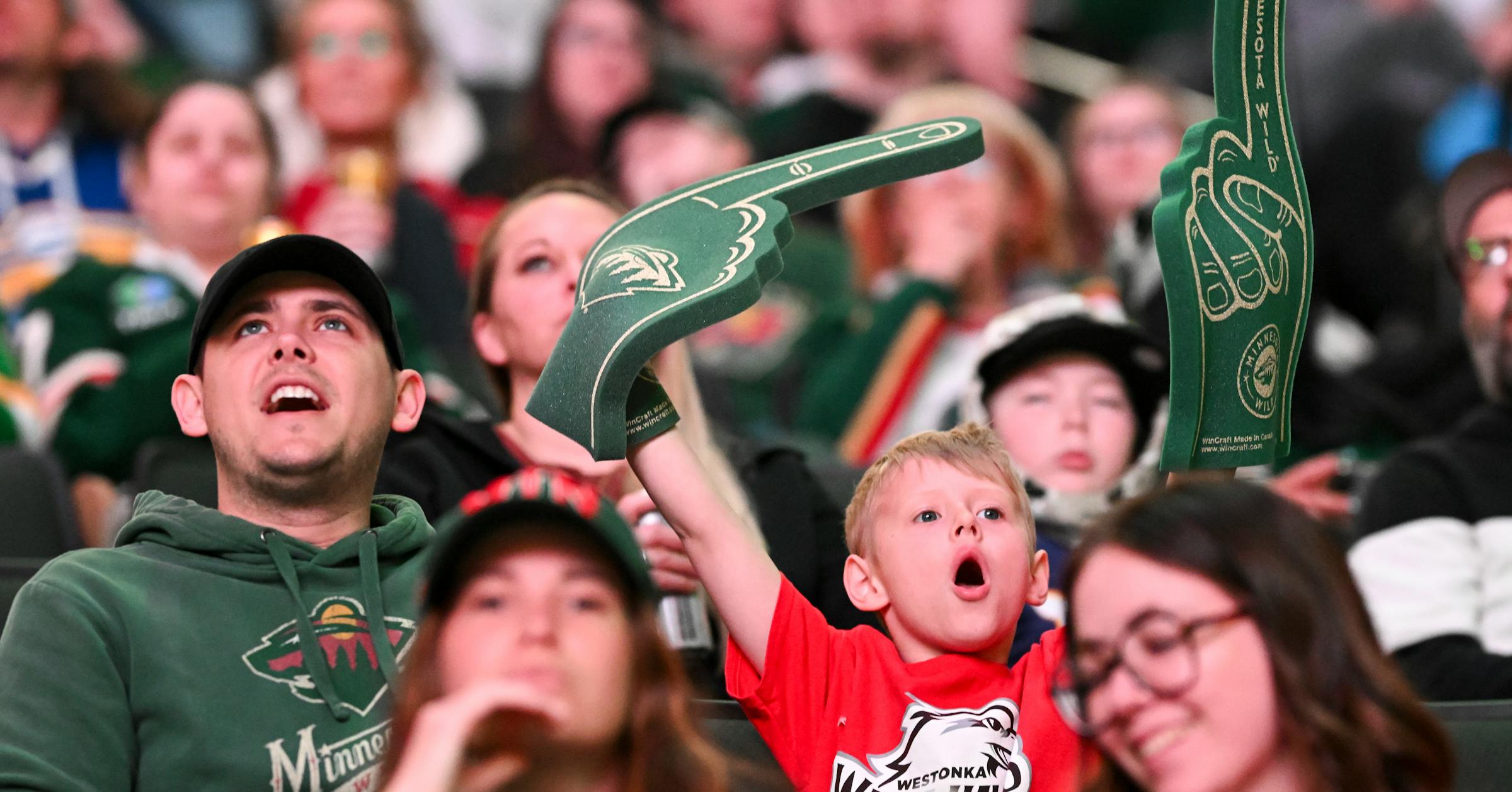 Wild fans cheer on their team in Game 1