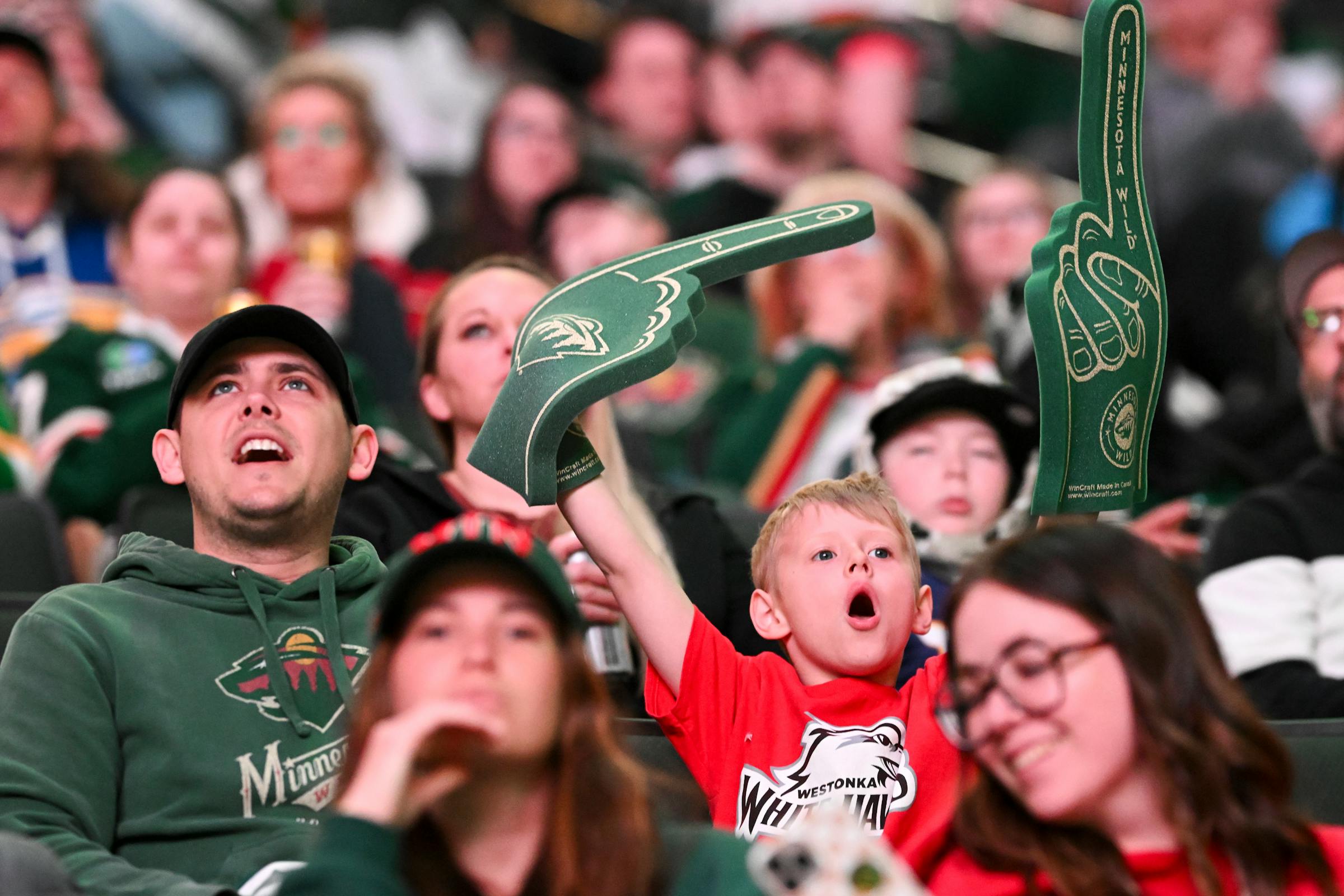 Wild fans cheer on their team in Game 1