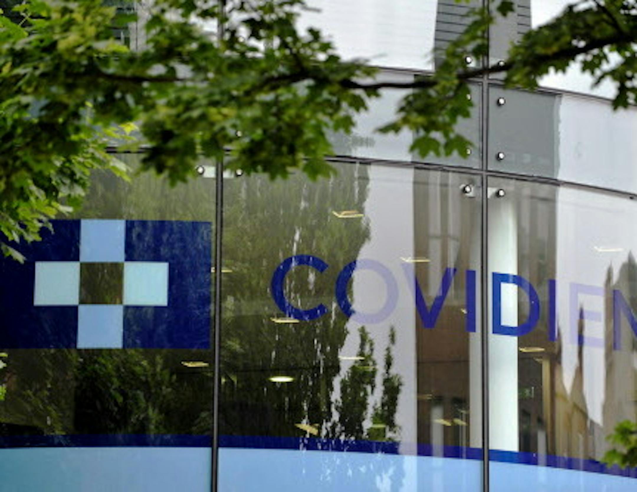A Covidien logo sits on the glass windows of medical device manufacturer Covidien Plc's head office in Dublin, Ireland, on Monday, June 16, 2014. Medtronic Inc., the second-largest maker of medical devices, agreed to buy Covidien for $42.9 billion in cash and stock as it transforms into a broader-based company bolstered by new tax advantages. Photographer: Aidan Crawley/Bloomberg ORG XMIT: 498097627