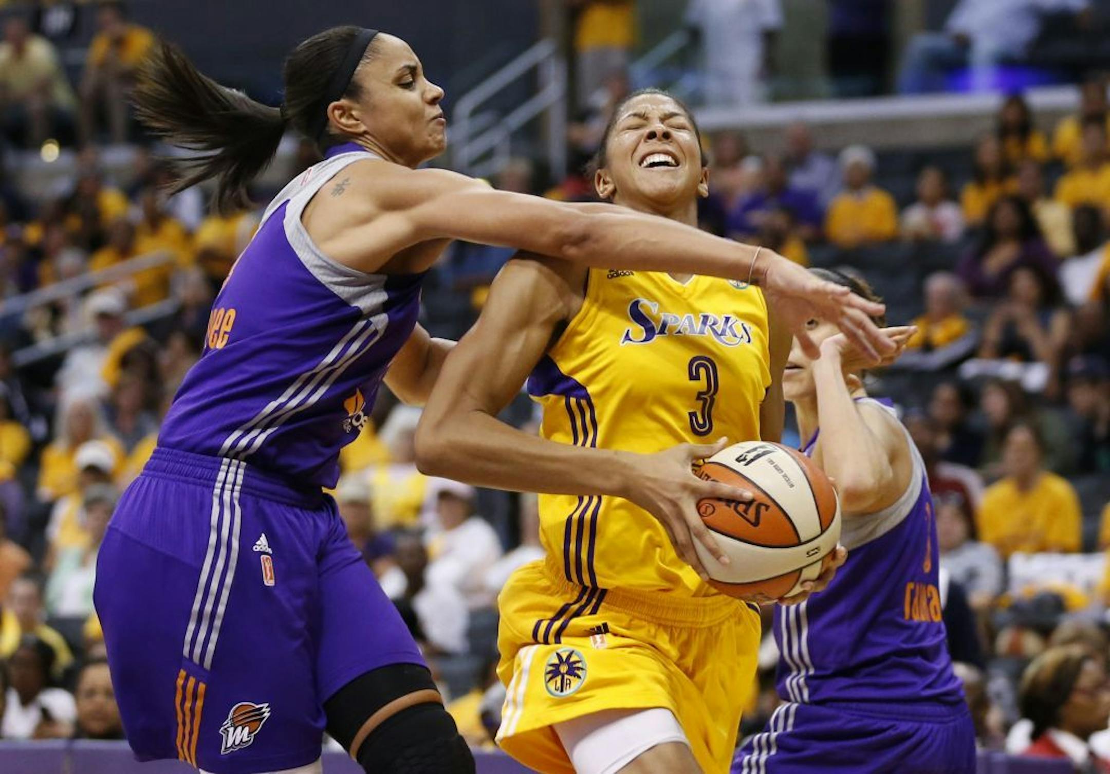 Phoenix Mercury's Candice Dupree, left, fouls Los Angeles Sparks' Candace Parker as Mercury's Diana Taurasi also defends during the second half in Game 1 of their WNBA Western Conference semifinal series.