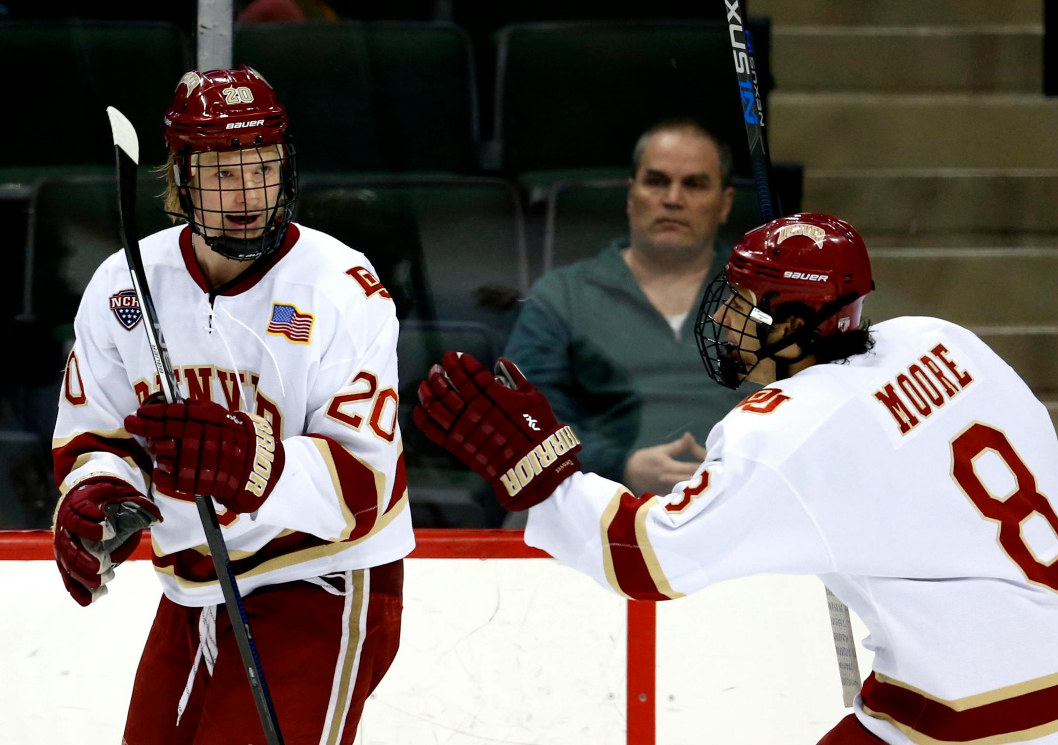 Danton Heinen (20) and Trevor Moore (8) of Denver celebrated a goal by Heinen in the first period Sunday during the Pioneers' 6-3 victory over Ferris State in the NCAA West Regional at Xcel Energy Center.
