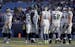 Seattle Seahawks quarterback Russell Wilson, left, pulls out of the huddle during the first half in an NFL football game against the Los Angeles Rams 