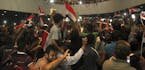 Supporters of Shiite cleric Muqtada al-Sadr storm parliament in Baghdad's Green Zone, Saturday, April 30, 2016. Dozens of protesters climbed over the 