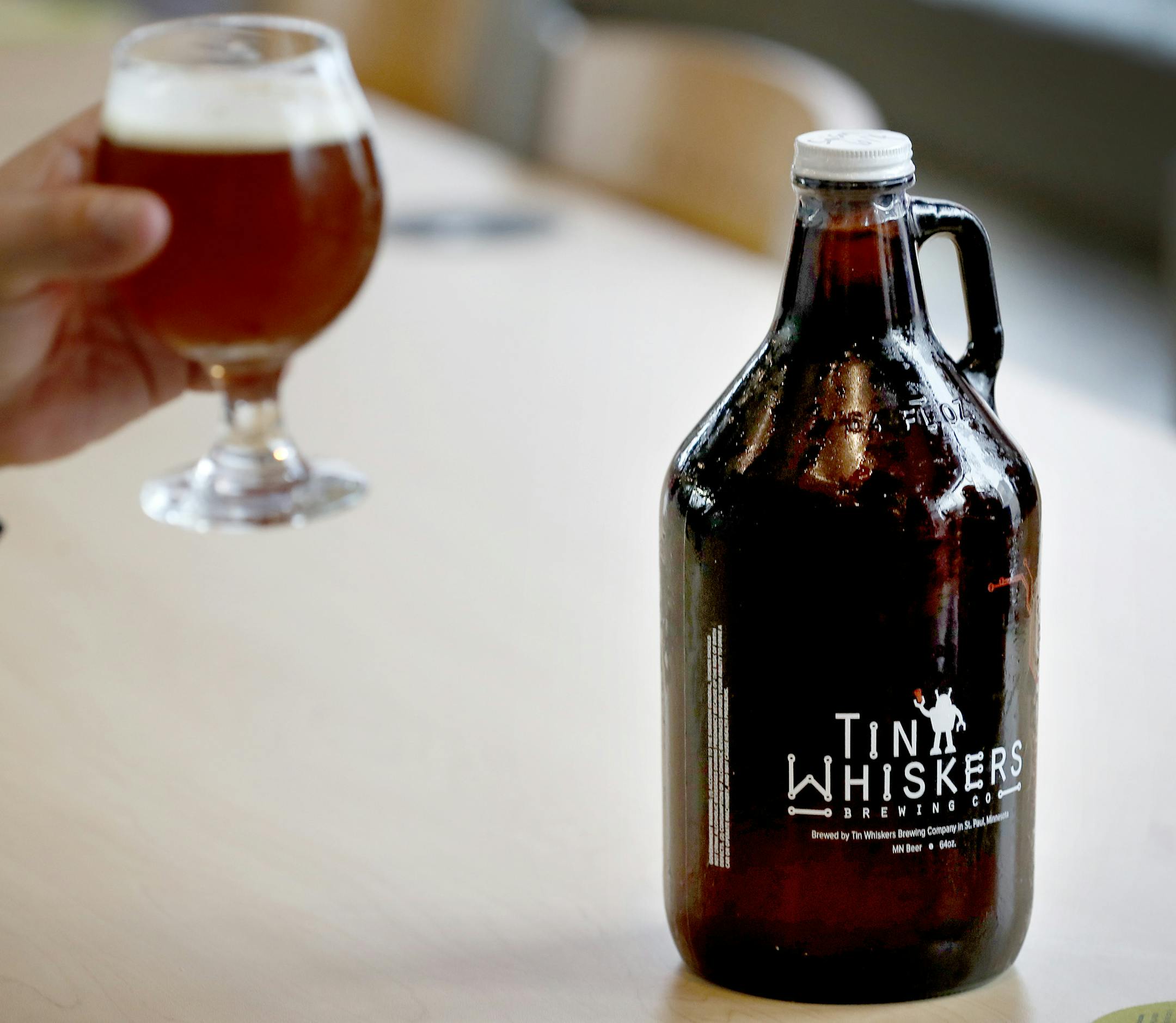 A growler sat on a table at Tin Whiskers in St. Paul. ] CARLOS GONZALEZ cgonzalez@startribune.com - October 4, 2016, St. Paul, MN, Tin Whiskers, one of the breweries that would be impacted by the change in liquor sale hours. They currently cannot sell growlers after 8 p.m. on weekdays, and this regulatory change would push that to 10 p.m.