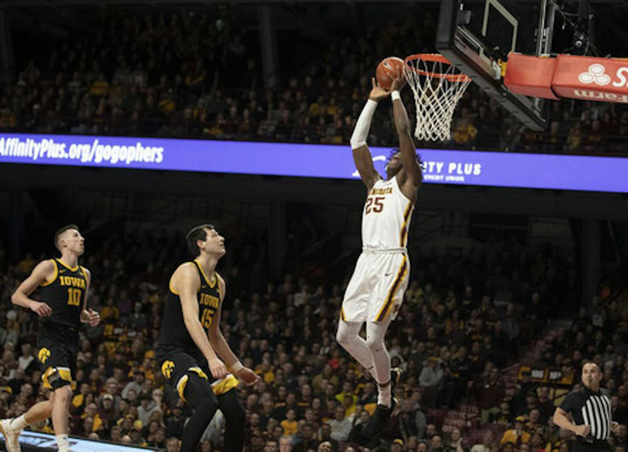 Minnesota Gophers center Daniel Oturu dunkS over Iowa Hawkeyes forward Ryan Kriener (15) in the first half Sunday, Feb. 16, 2020 at Williams Arena in Minneapolis, Minn. (Jerry Holt/Minneapolis Star Tribune/TNS) ORG XMIT: 1575163