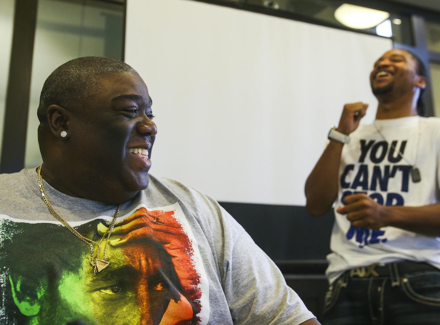 Ferome Brown, left, laughs while reminiscing with Tyron Jenkins, right, about an interesting run-in Jenkins had asking his mentee about how to keep youth involved and out of trouble in the community at EMERGE Community Development on June 27, 2016. Brown was once involved in drug activity, spending more than six years in prison after he was caught dealing drugs. He started his own nonprofit called Urban Youth Conservation in 2005 to provide young people in different cliques an opportunity to imp