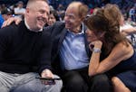 Tim Connelly, the Timberwolves' president of basketball operations, shares a laugh with owner Glen Taylor, center, and Taylor's wife, Becky, right, in