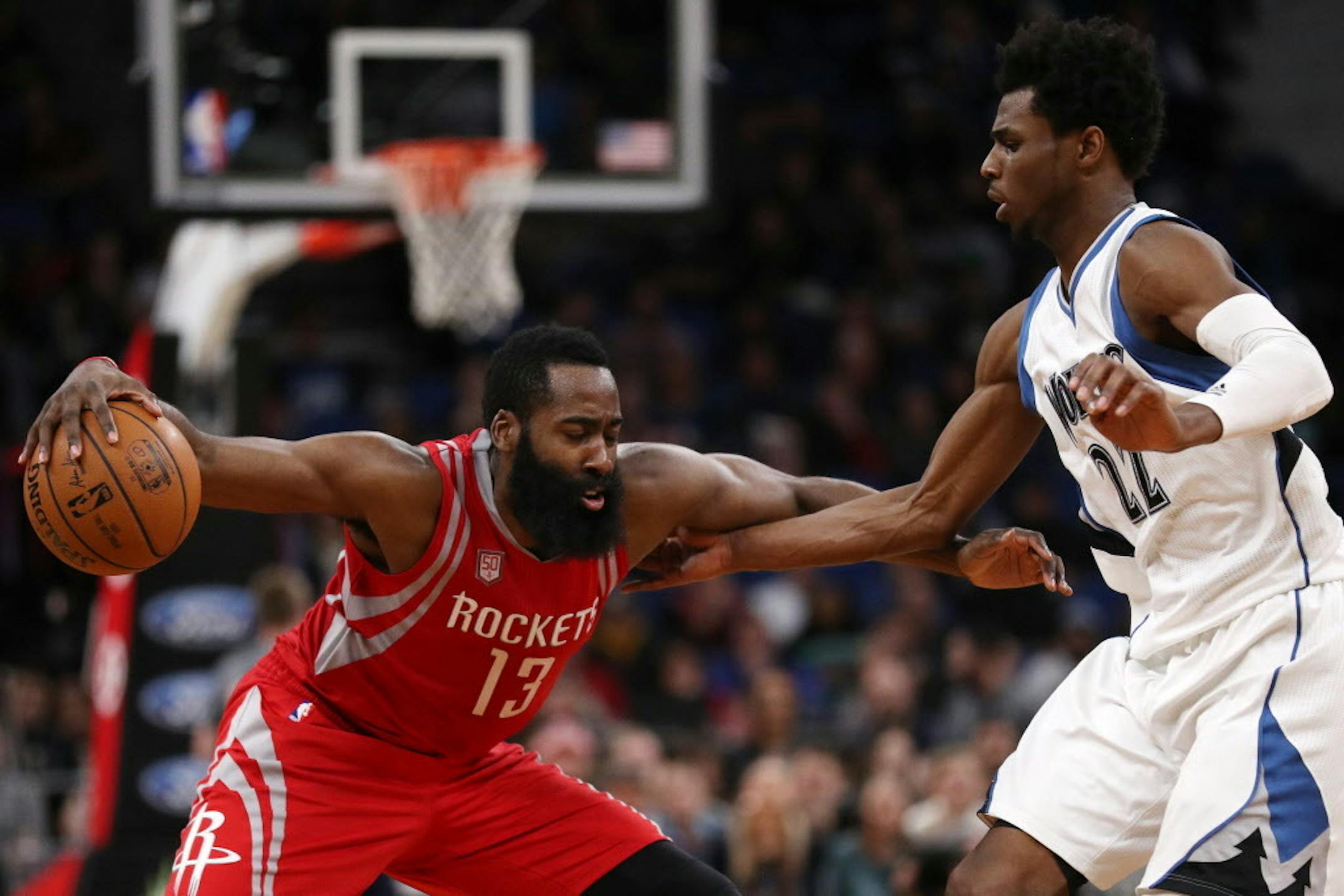 Timberwolves forward Andrew Wiggins (22) tries to defend against Houston Rockets guard James Harden (13).
