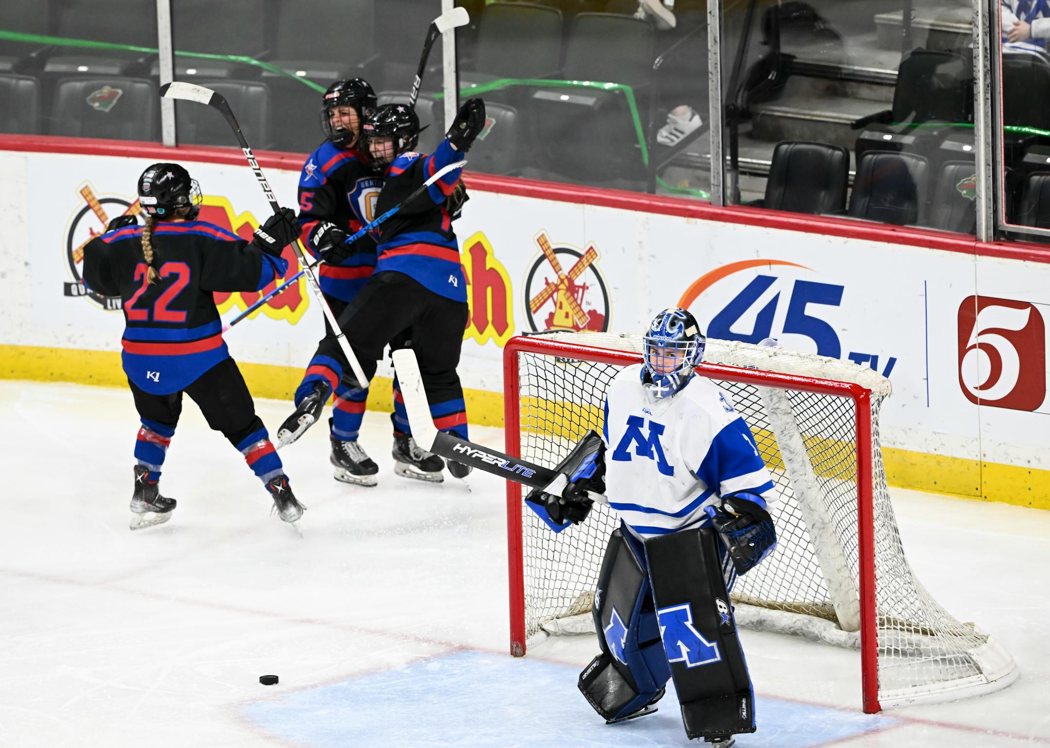 Teammates celebrate the game-tying goal scored by Gentry forward Alexa Hanrahan (5) against Minnetonka goaltender Layla Hemp (1) during the third period.