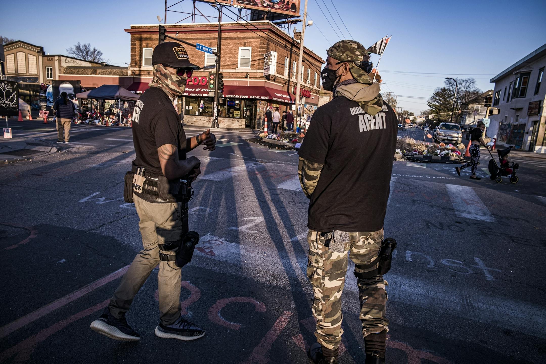 Ricky Wafford, left and Lee Coleman who wore "Street Veterans" shirts checked out the George Floyd memorial site on the election night of 11/03/2020. They claimed to be part of a private security company and were carrying handguns.