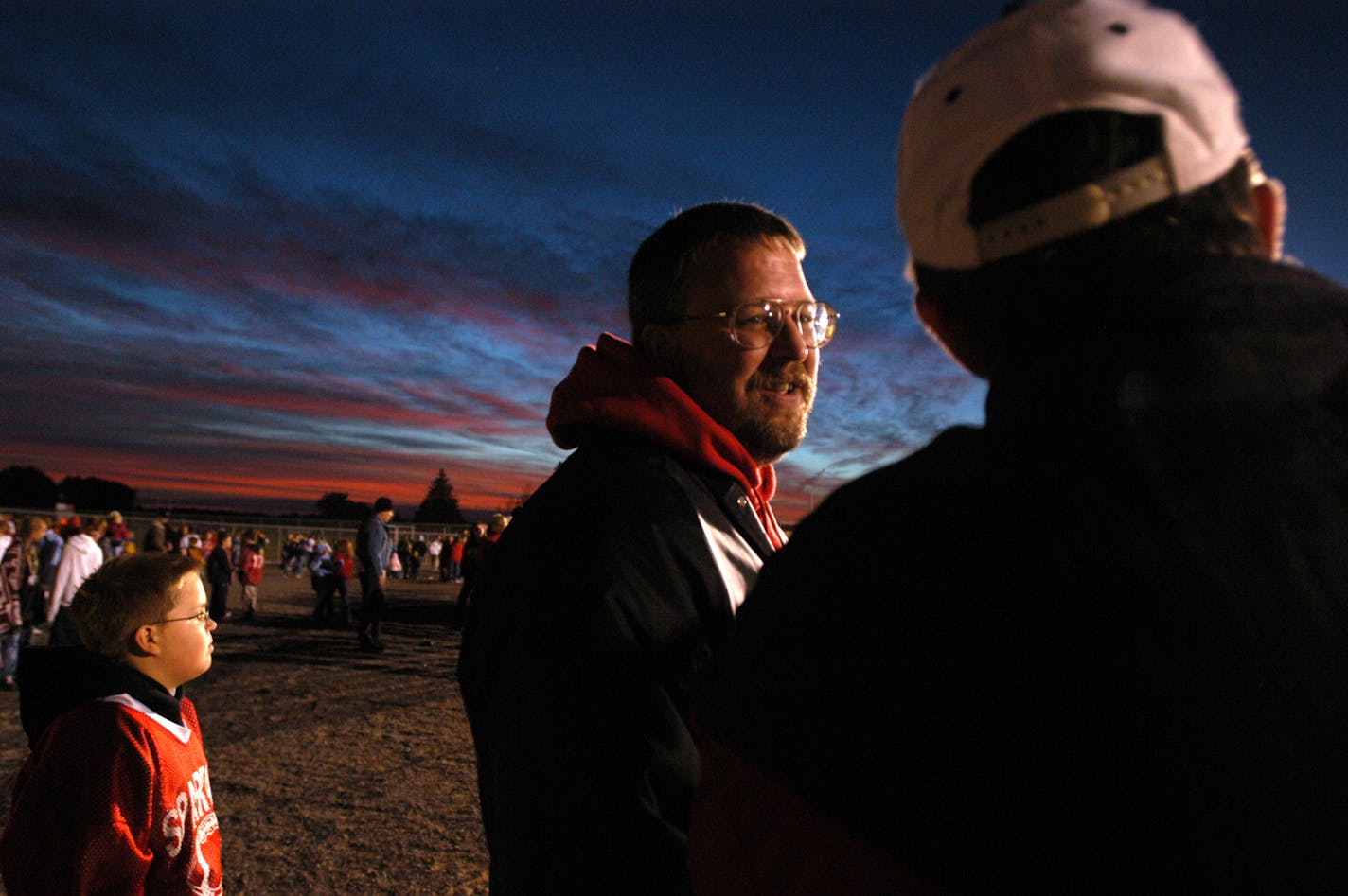 File photo by Kyndell Harkness
After the 2003 shooting, Scott Staska emerged as a central community figure. Here he talks with Rocori High School principal Doug Standke during a home football game.