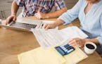 Senior couple checking their bills at home. istock