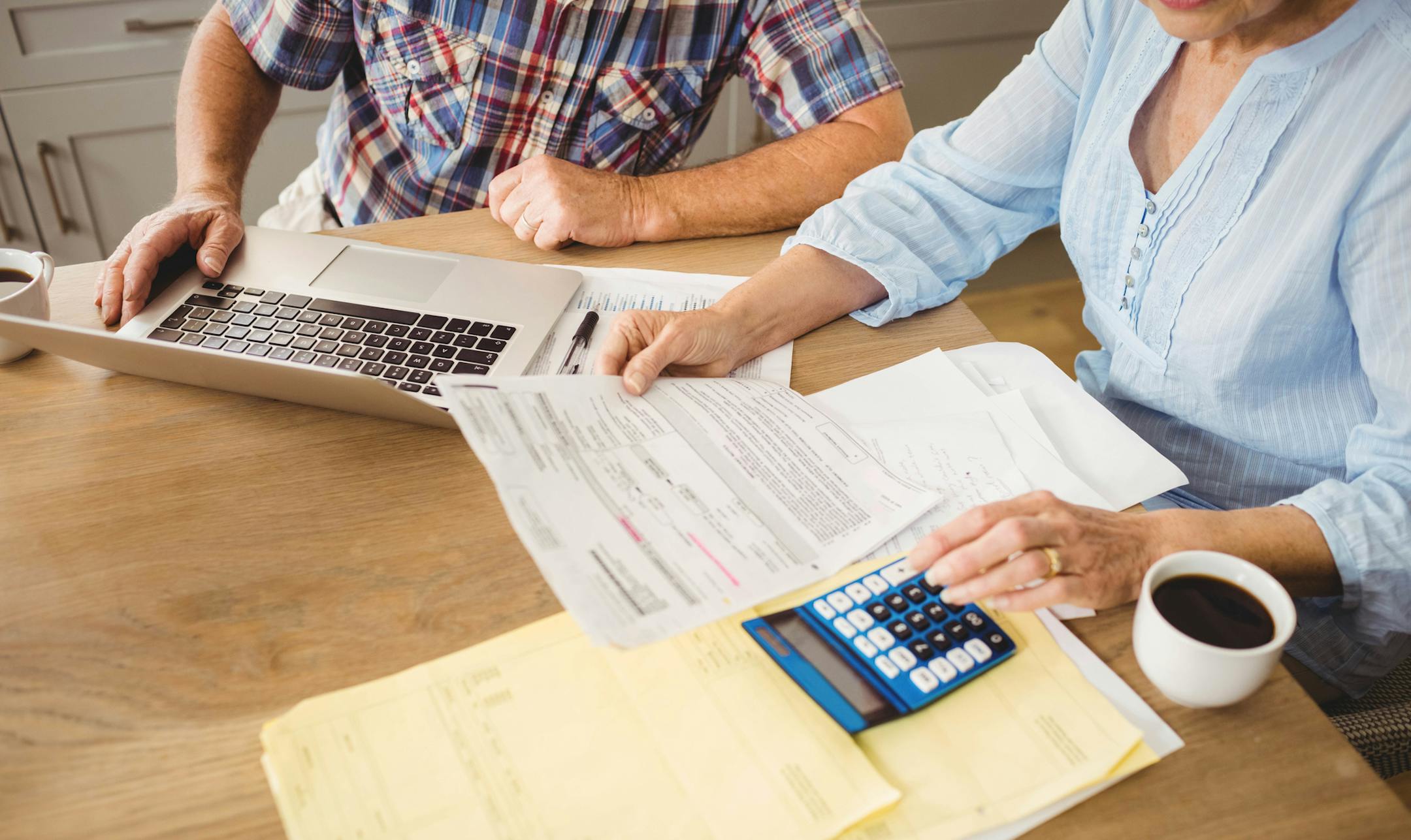 Senior couple checking their bills at home. istock