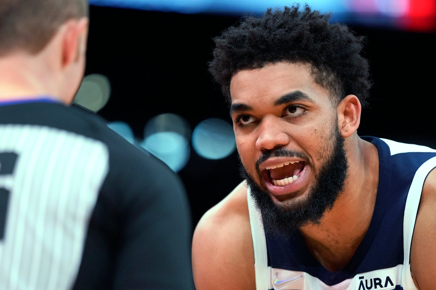 Minnesota Timberwolves center Karl-Anthony Towns, right, argues with referee Brandon Schwab during the second half of the team's NBA basketball game against the Houston Rockets, Sunday, April 3, 2022, in Houston. (AP Photo/Eric Christian Smith)