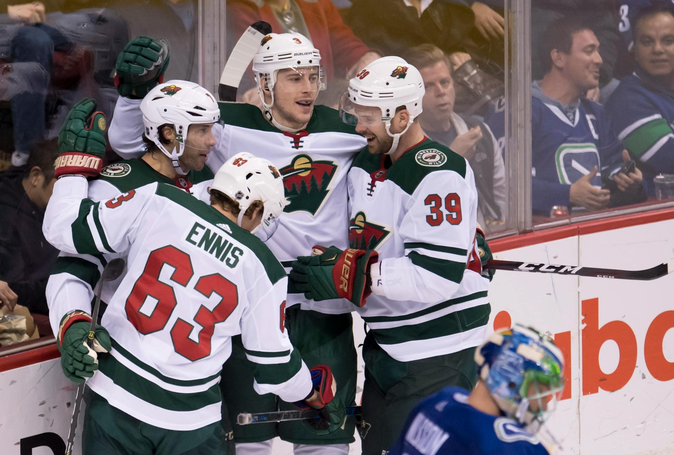 Minnesota Wild center Matt Cullen (7) celebrates his goal with left wing Tyler Ennis (63), defenseman Nate Prosser (39) and center Charlie Coyle (3) as Vancouver Canucks goaltender Anders Nilsson looks down during the second period of an NHL hockey game Friday, March 9, 2018, in Vancouver, British Columbia. (Jonathan Hayward/The Canadian Press via AP)